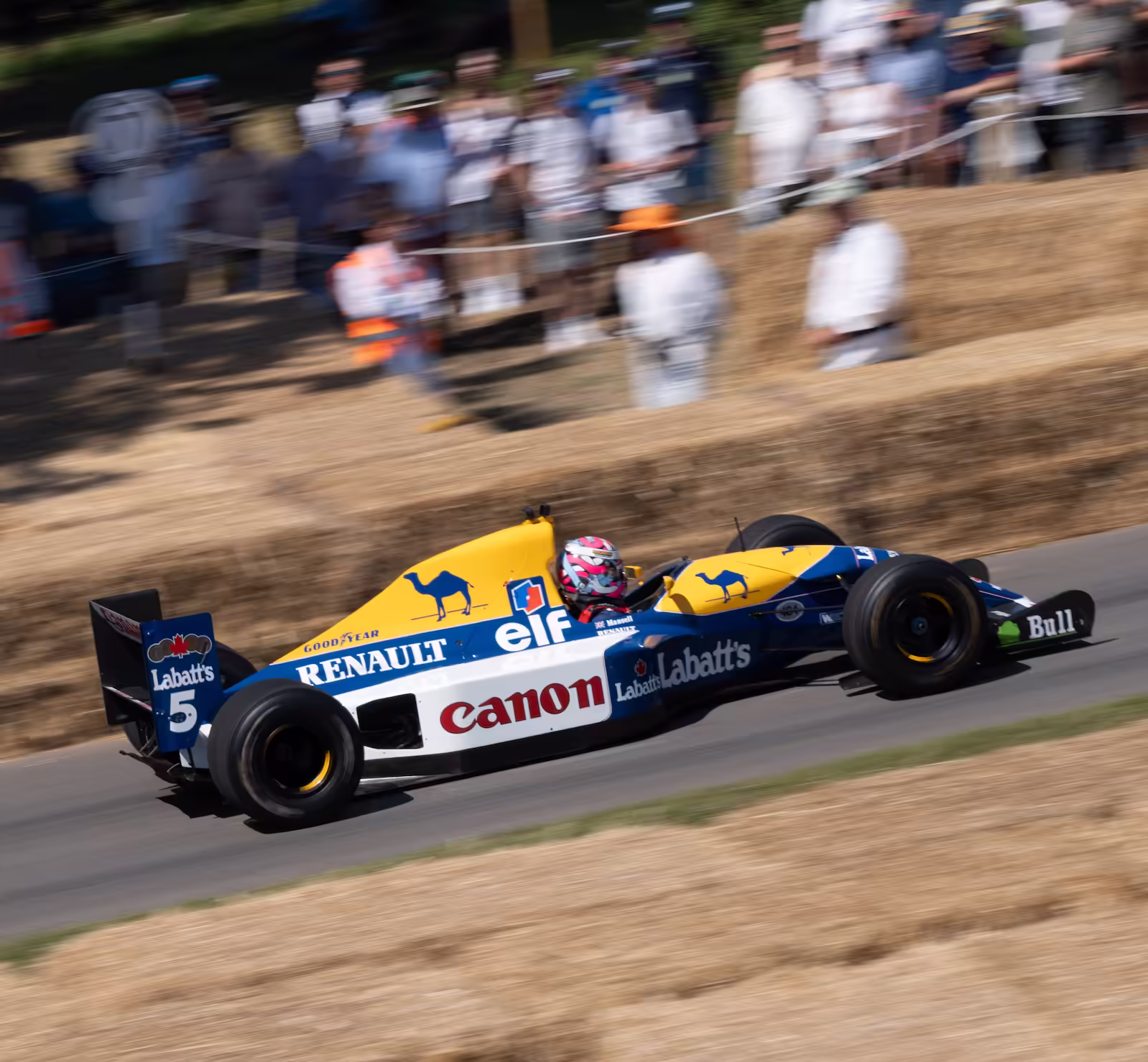 A old Williams F1 car speeding up a hill