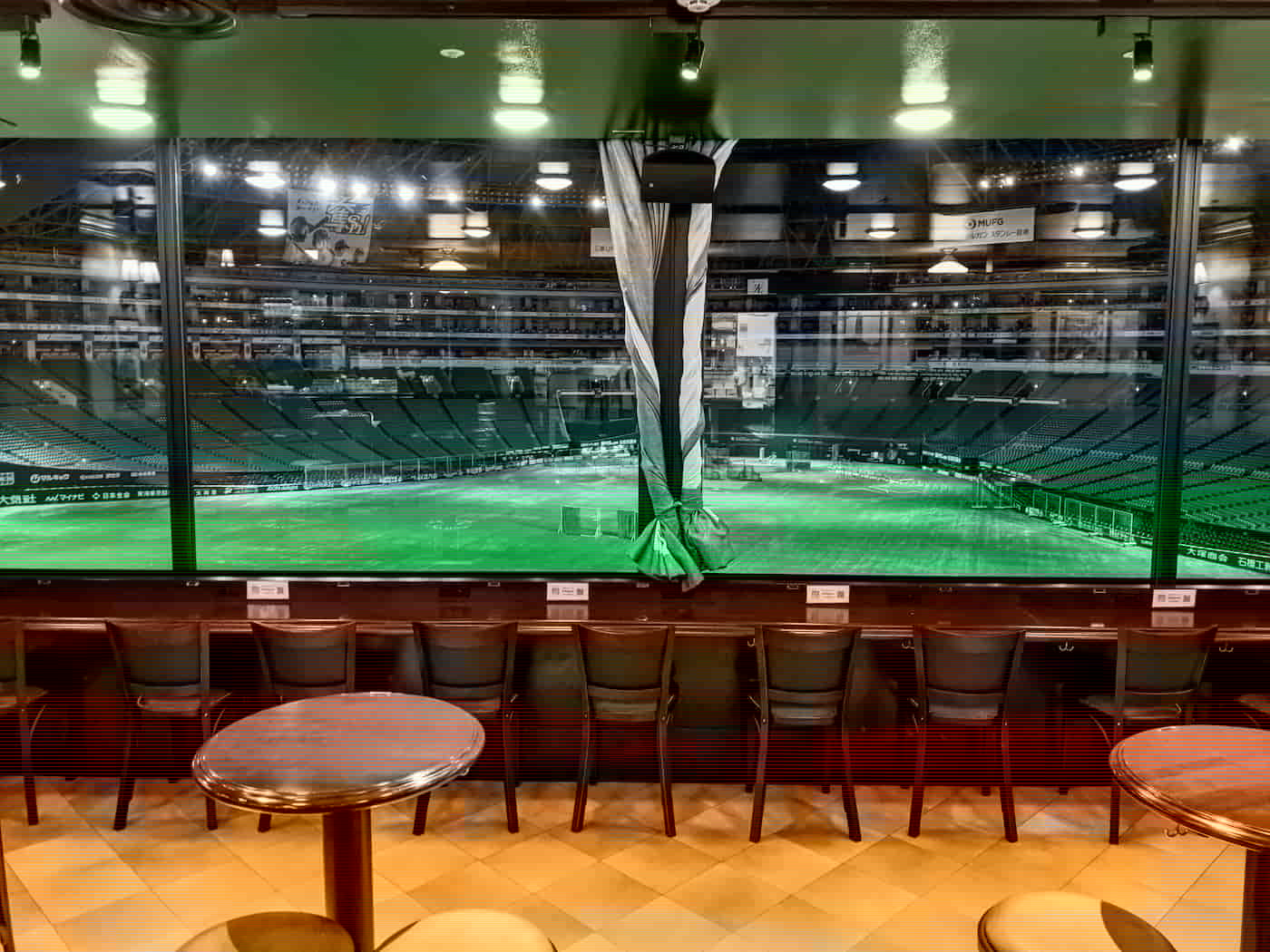 Pub window looking into a baseball stadium